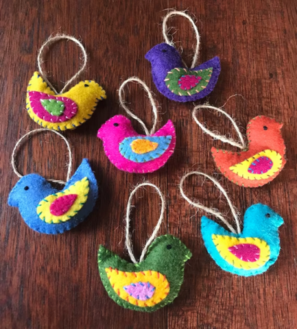 Several colorful felt birds with loop strings attached.